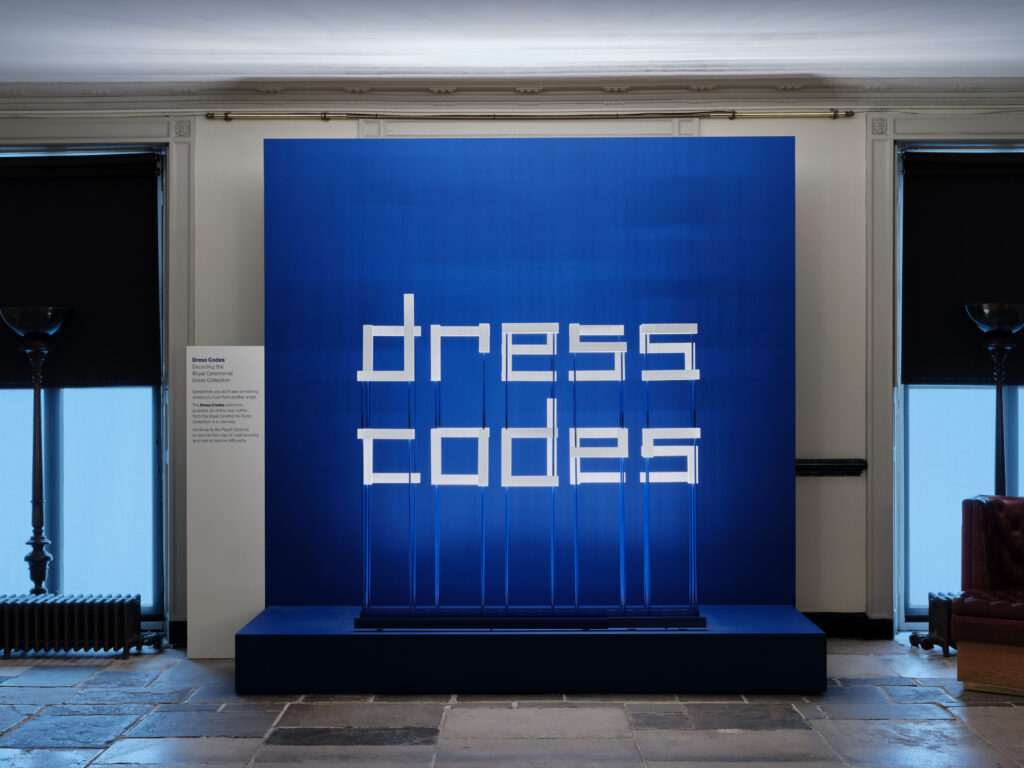 Temporary exhibition lighting design by Michael Grubb Studio, award-winning lighting consultants, highlighting historical garments in Dress Codes exhibition at Kensington Palace in London