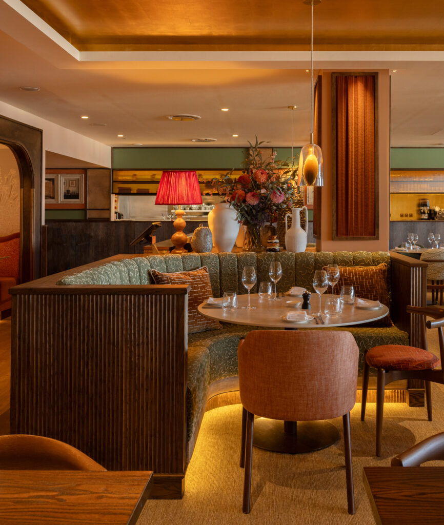 Sustainable restaurant lighting design in London, demonstrating adaptive reuse of existing lighting within a hospitality environment.