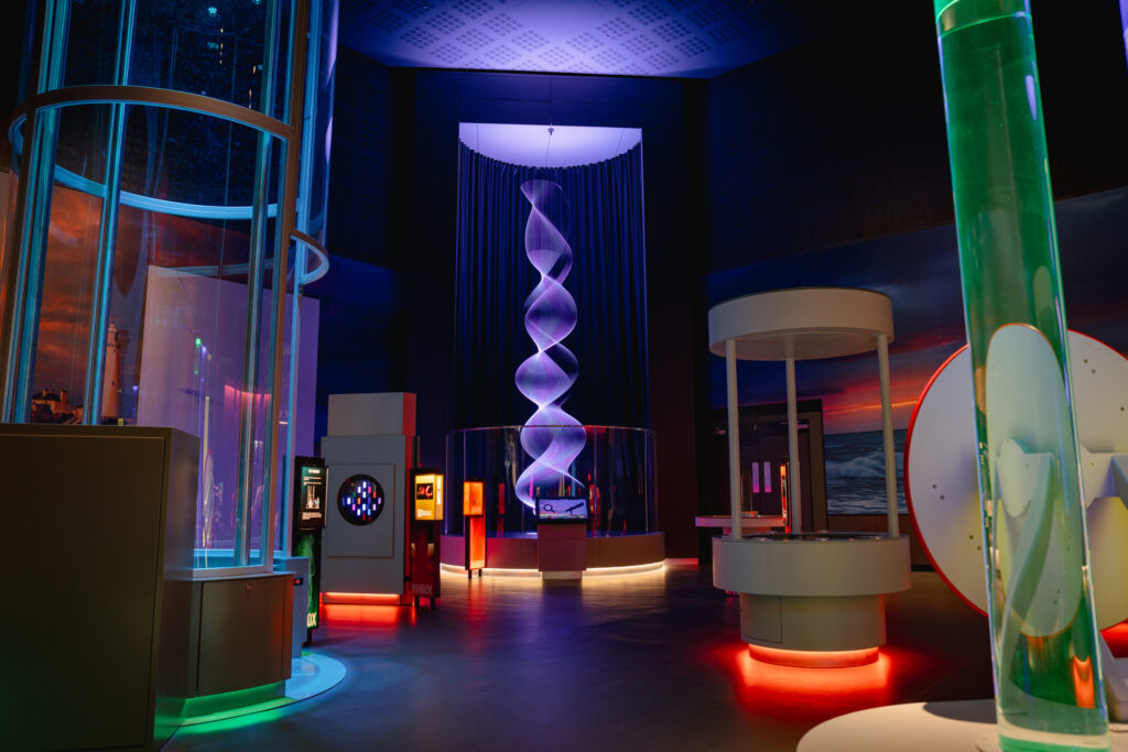 Visitor experience lighting design within an immersive science centre environment featuring interactive exhibits and experiential learning installations.