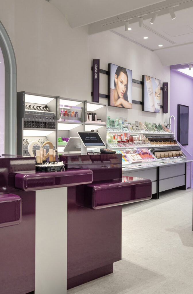 Commercial retail lighting for an Italian cosmetics store creating an engaging customer journey through layered showroom lighting.