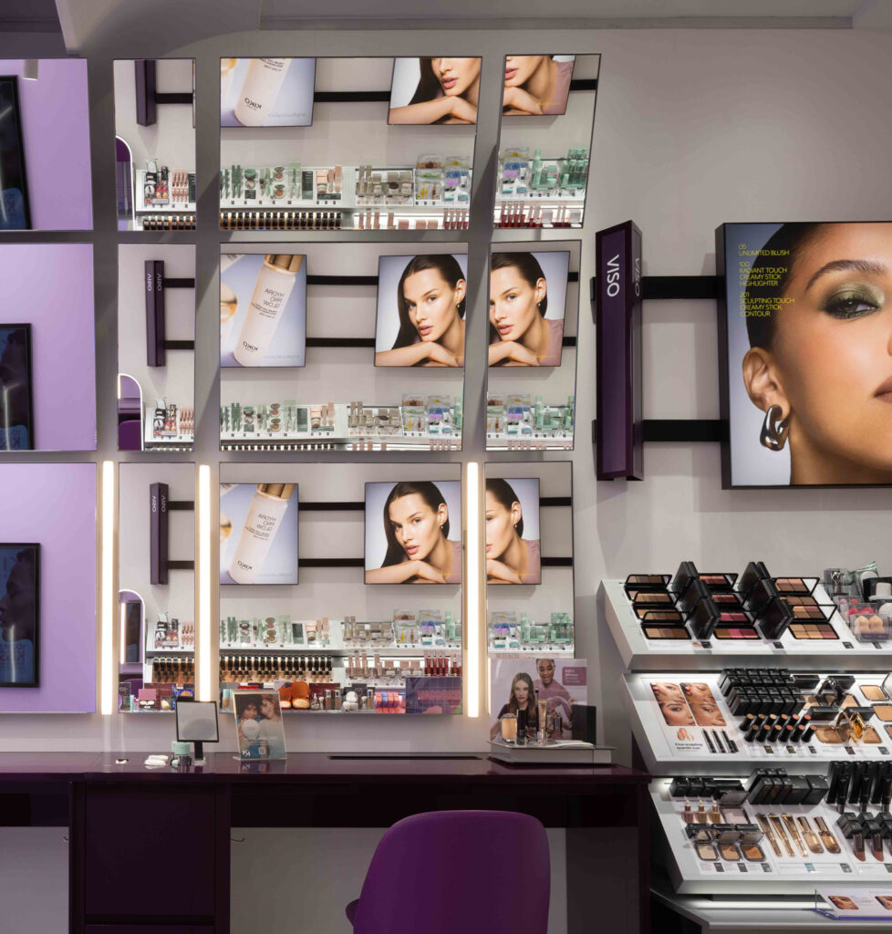 Retail display lighting highlighting cosmetics, shelving and merchandising within a contemporary beauty retail environment in Rome.