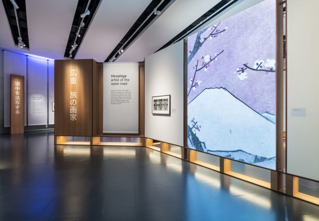 Museum exhibition lighting by Michael Grubb Studio for Hiroshige: Artist of the Open Road, using soft focused illumination to enhance artworks and visitor interpretation.